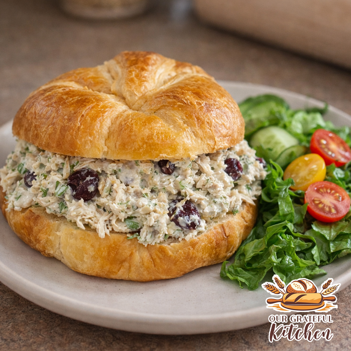 classic chicken salad croissant sandwich with cranberries celery and dill served on a plate