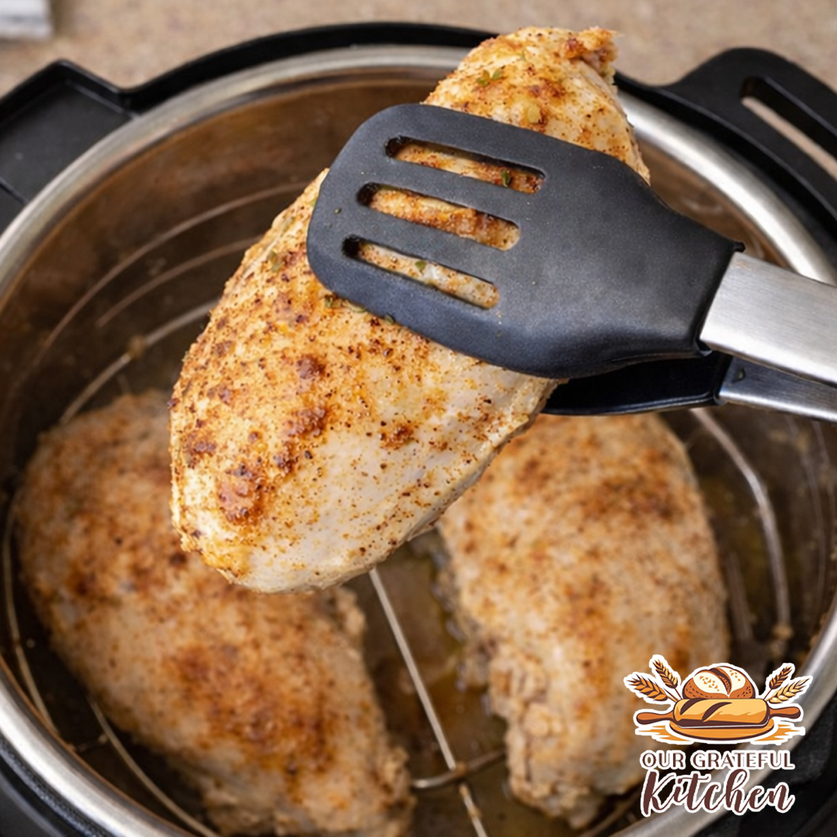 Removing cooked chicken breast from the Instant Pot with silicone tipped tongs
