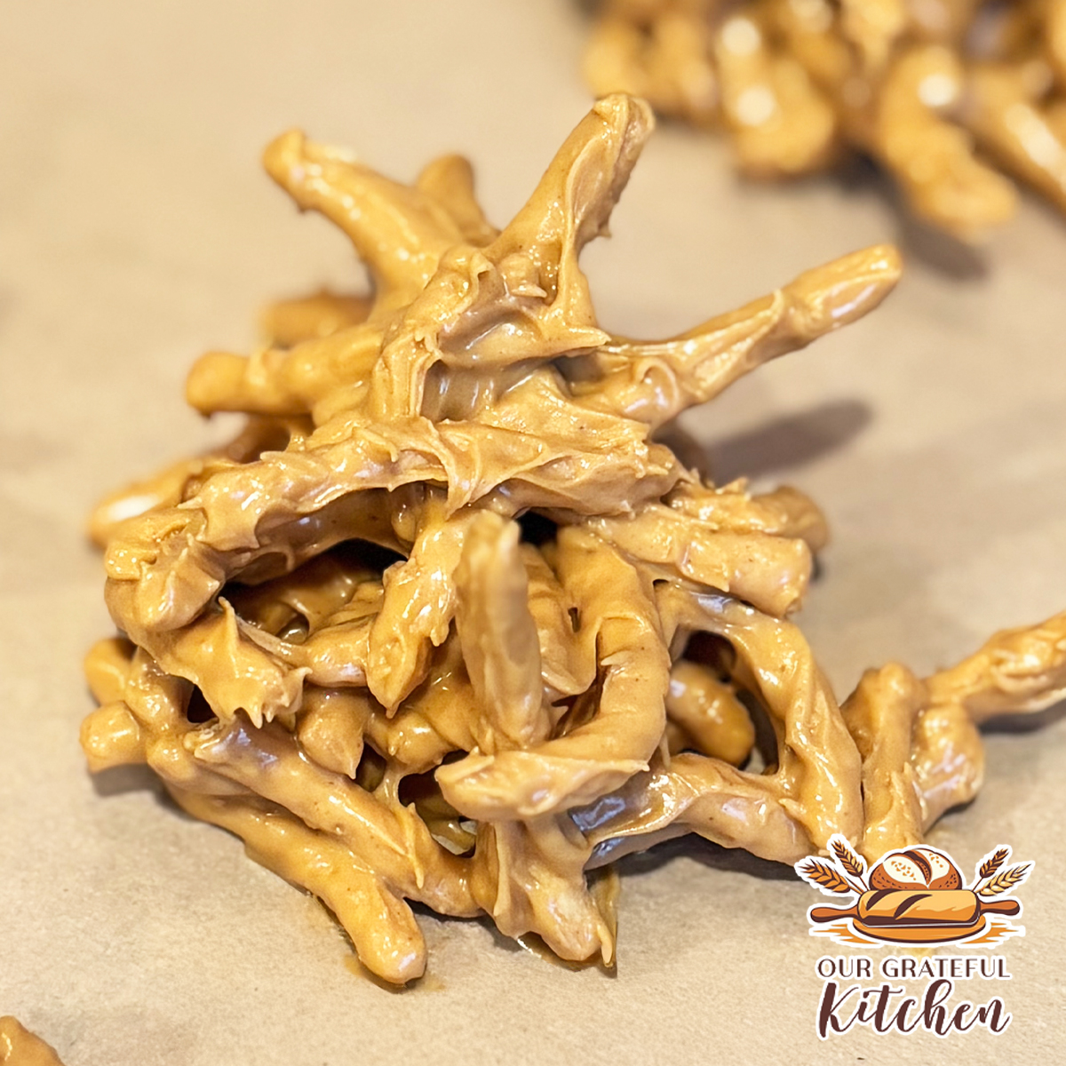 No bake butterscotch haystack cookies made with chow mein noodles and melted butterscotch chips on parchment paper