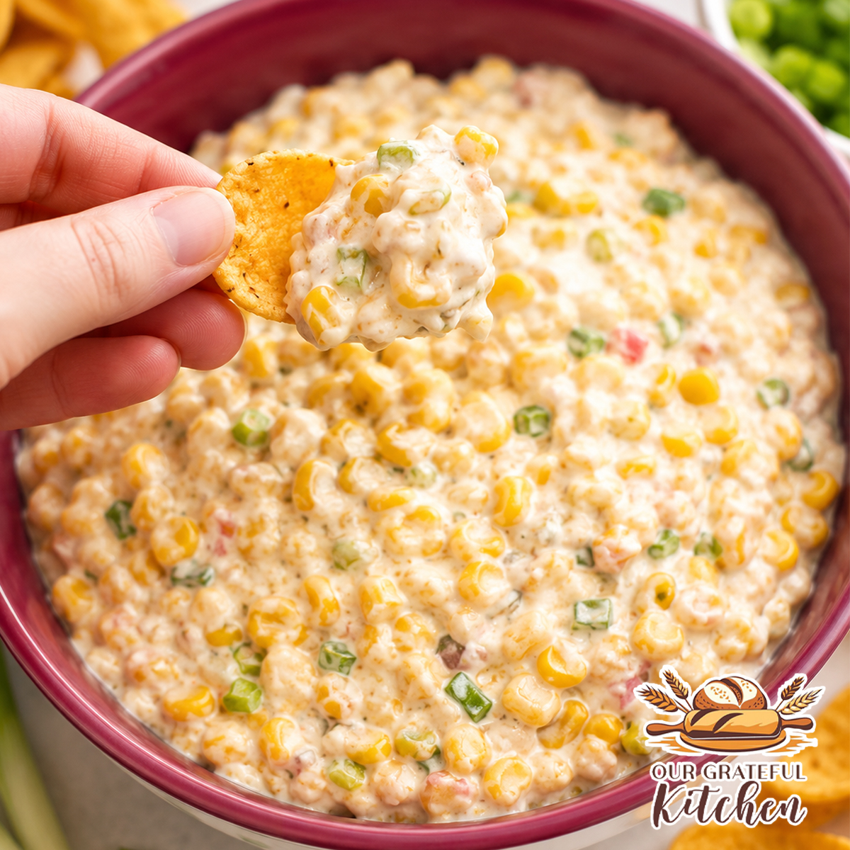 Creamy Southwest Corn Dip served in a bowl with corn chips, made with Mexican-style corn, cheddar cheese, ranch seasoning, green chiles, mayonnaise, and Greek yogurt.