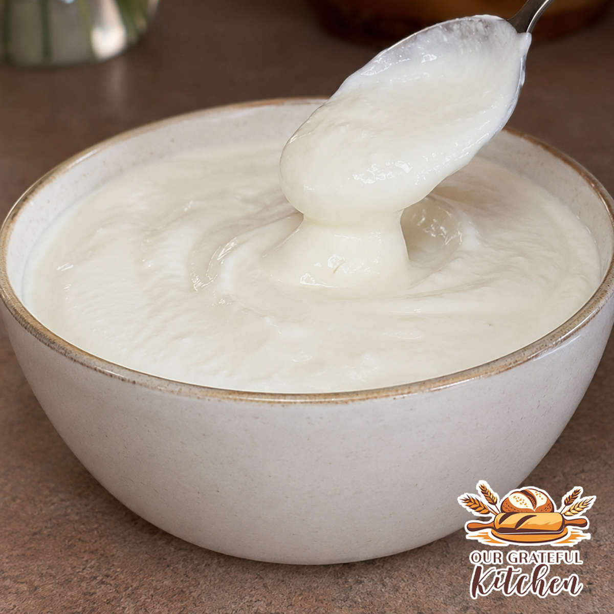 Creamy easy homemade sour cream substitute served in a white bowl, made with heavy whipping cream, vinegar, lemon juice, and sea salt.