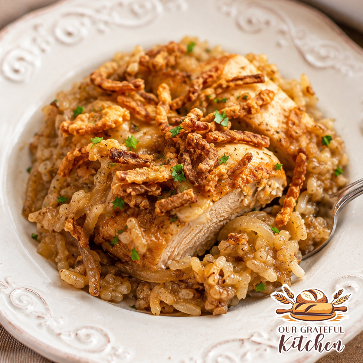 Plated French onion chicken and rice casserole topped with crispy fried onions