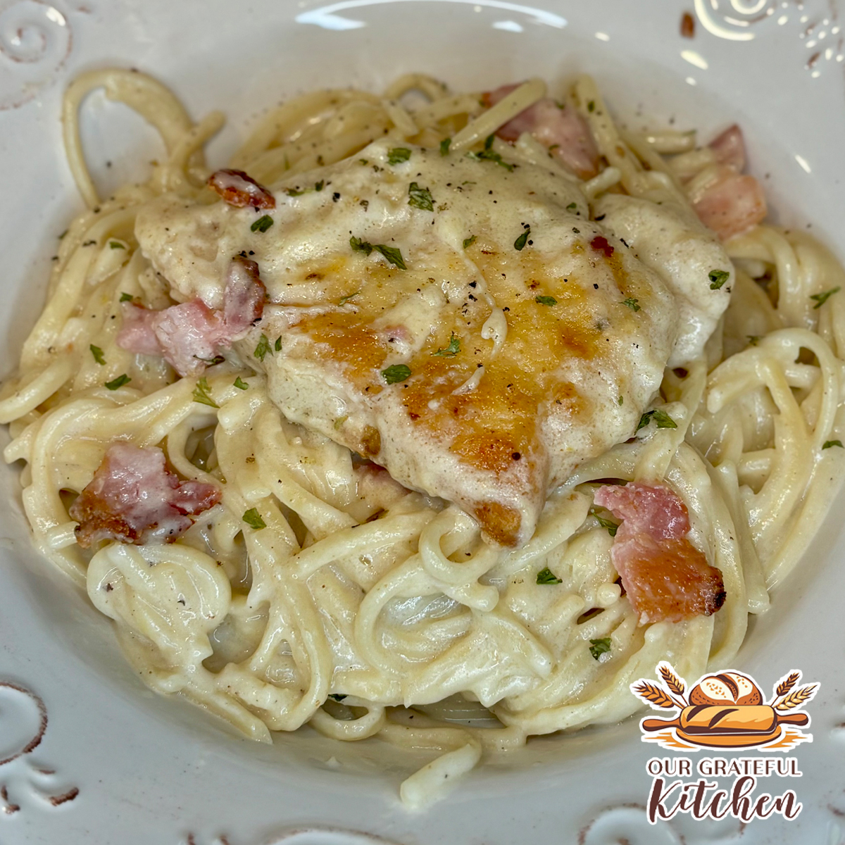 Smothered chicken pasta with golden pan-fried chicken, creamy linguine, crispy bacon, and homemade sauce.